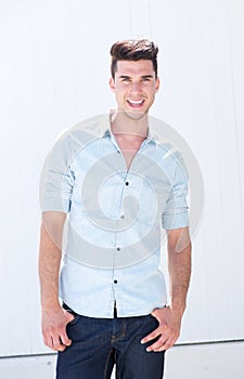 Handsome young man smiling outdoors