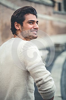 Handsome young man smiling, outdoors. Urban style.