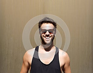 Handsome young man smiling with sunglasses