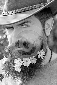 Handsome young man on spring background looking at camera.