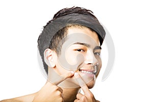 Handsome young man Squeezing pimple