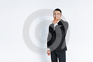 Handsome young man in a stylish suit, posing on a white background isolated