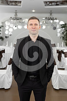 Handsome young man in a suit in a restaurant.