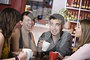 Handsome Young Man Surrounded by Women photo