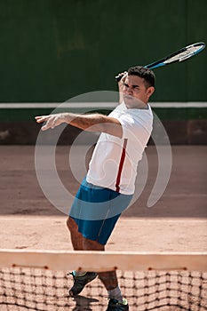 Handsome young man on tennis court.