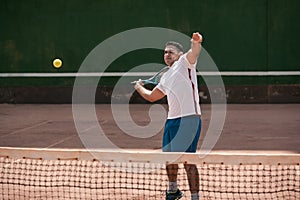 Handsome young man on tennis court.