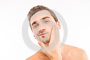 Handsome young man touching his face after shave photo