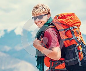 Handsome young man tourist backpacker portrait on Himalaya mount