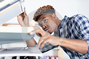 handsome young man using copy machine