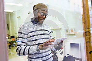 Handsome young man using his digital tablet at home.
