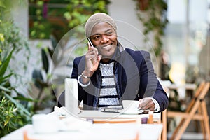 Handsome young man using his mobile phone in the cafe.