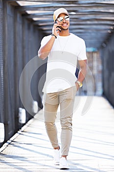 Handsome young man using his mobile phone in the street.