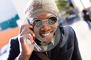 Handsome young man using his mobile phone in the street.