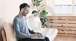 Handsome young man using laptop computer at home, Businessman warking in his room, Home work or study, freelance concept