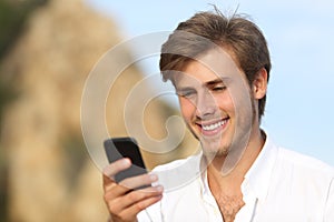 Handsome young man using a mobile phone outdoor