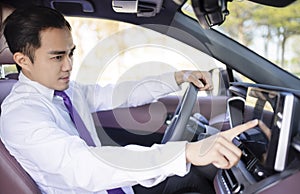 Handsome young Man using navigation system while driving car