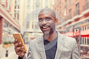 Handsome young man using smart phone outdoors