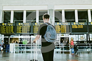 Handsome young man walking in the airport.