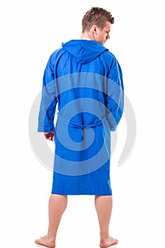 Handsome young man wearing blue bathrobe, isolated