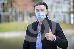 Handsome young man wearing corona mask