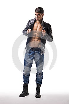 Handsome young man wearing leather jacket on naked