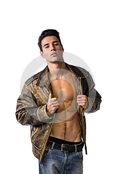 Handsome young man wearing leather jacket on naked torso, isolated on white