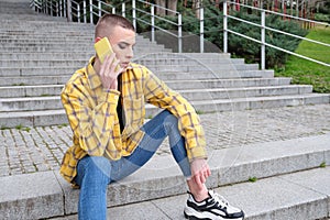 Handsome young man wearing make up, talking on his smartphone upset