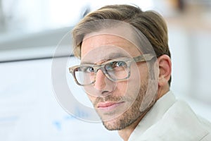 Handsome young man wearing trendy eyeglasses