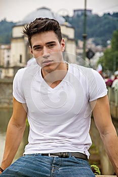 Handsome young man in white t-shirt outdoor in