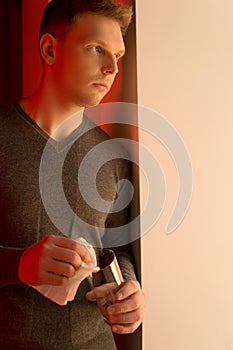 Handsome young man wiping glasses.