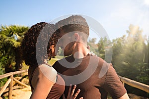 Handsome young man and woman dancing bachata and salsa in the park. The couple dance passionately surrounded by greenery. Dancing