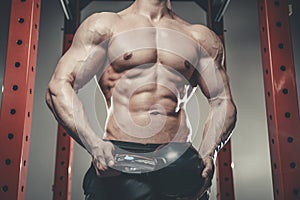 Handsome young man working out in gym kettlebell