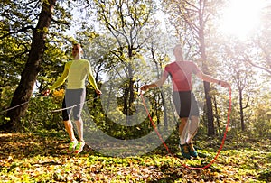 Handsome young men wearing sportswear and exercising in forest a