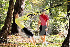 Handsome young men wearing sportswear and exercising in forest a