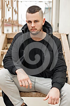 Handsome young model of a man with a short haircut in a winter