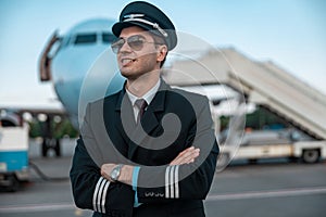 Handsome young pilot in uniform waiting for flight