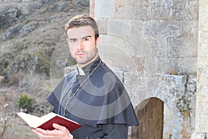 Handsome young priest close up with copy space