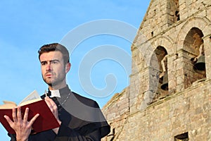 Handsome young priest close up with copy space