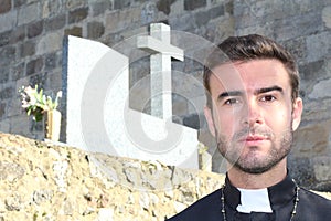 Handsome young priest close up looking seductive with copy space