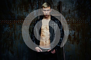 Handsome young shirtless man in leather jacket