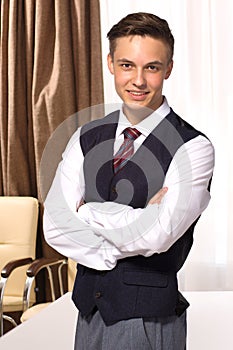 Handsome young smiling businessman in the boardroom