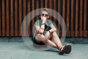 Handsome young stylish guy with sunglasses in beach fashion