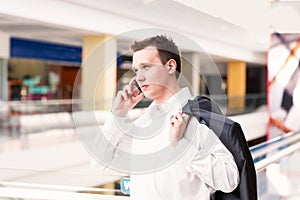 Handsome young and successful businessman talking on his mobile phone