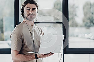 handsome young support hotline worker with laptop