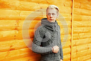 Handsome young teenager with hairdo in fashionable knitted