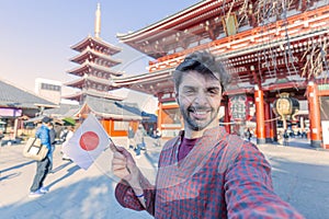 Handsome young tourist enjoying summer holiday in Tokyo, Japan - Traveling life style concept with smiling man taking selfie on