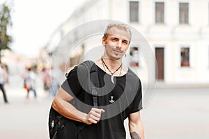 Handsome young tourist man in a black stylish T-shirt