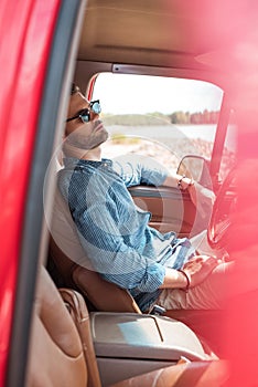 handsome young traveler in sunglasses relaxing