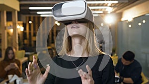 Handsome young woman wearing virtual reality vr glasses on the office background.