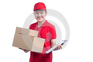 Handsome young worker in red t-shirt and cap smiling, holding a